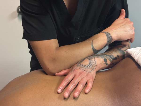 Massage therapist working on a client's back
