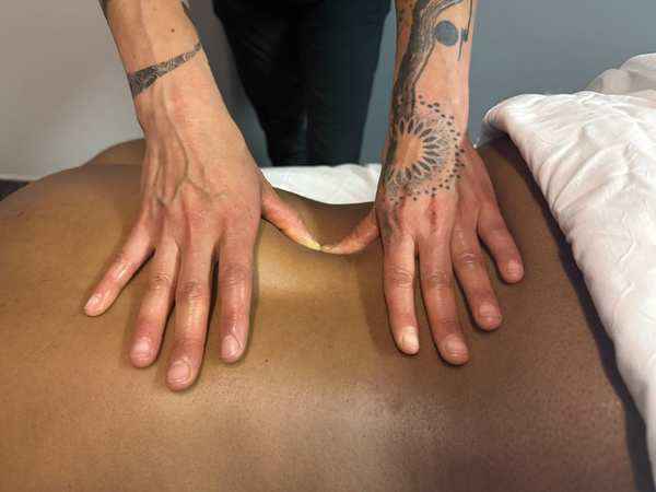 Massage therapist performing hands-on treatment