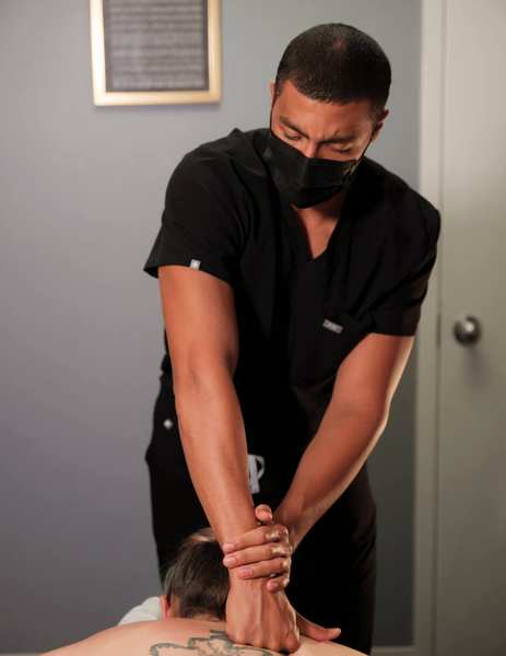 Massage therapist performing a deep tissue massage for CrossFit