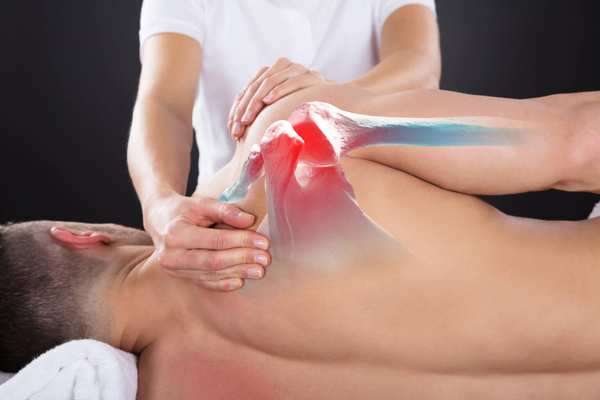 CrossFit and weightlifting massage with a therapist massaging a shoulder