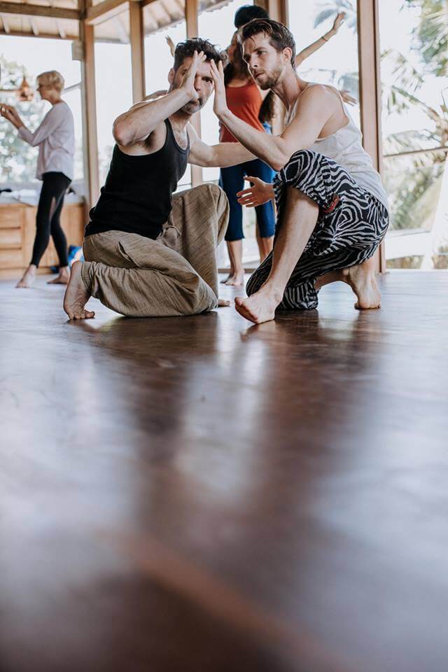 Body Mechanics Orthoepdic Massage new hire Sports and Medicinal Massage Therapist Zachary Koval kneeling a partner at a dance event