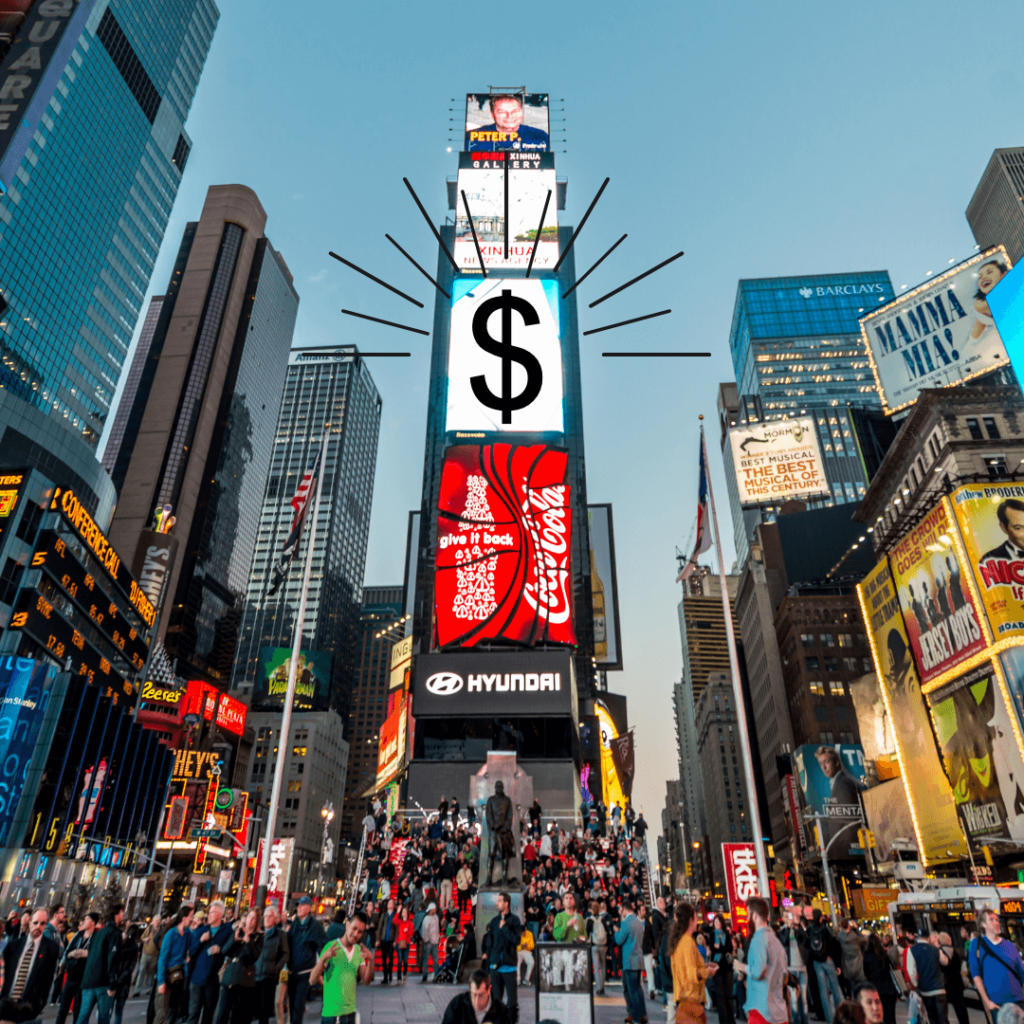 Picture of NYC times square with a money sign on a billboard. People are milling around the square. 