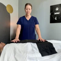 swedish massage therapy nyc - massage therapist holding space over a client