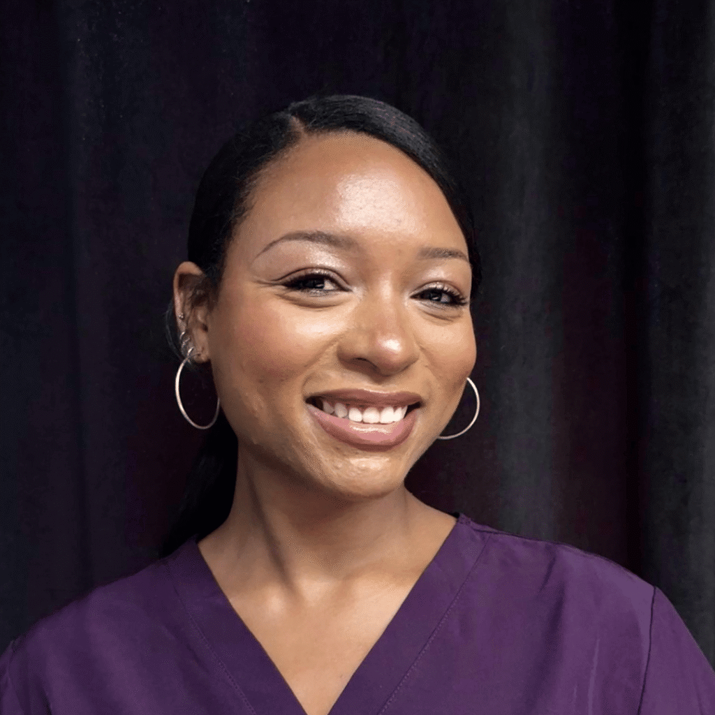 Miashe LMT/massage therapist in purple scrubs