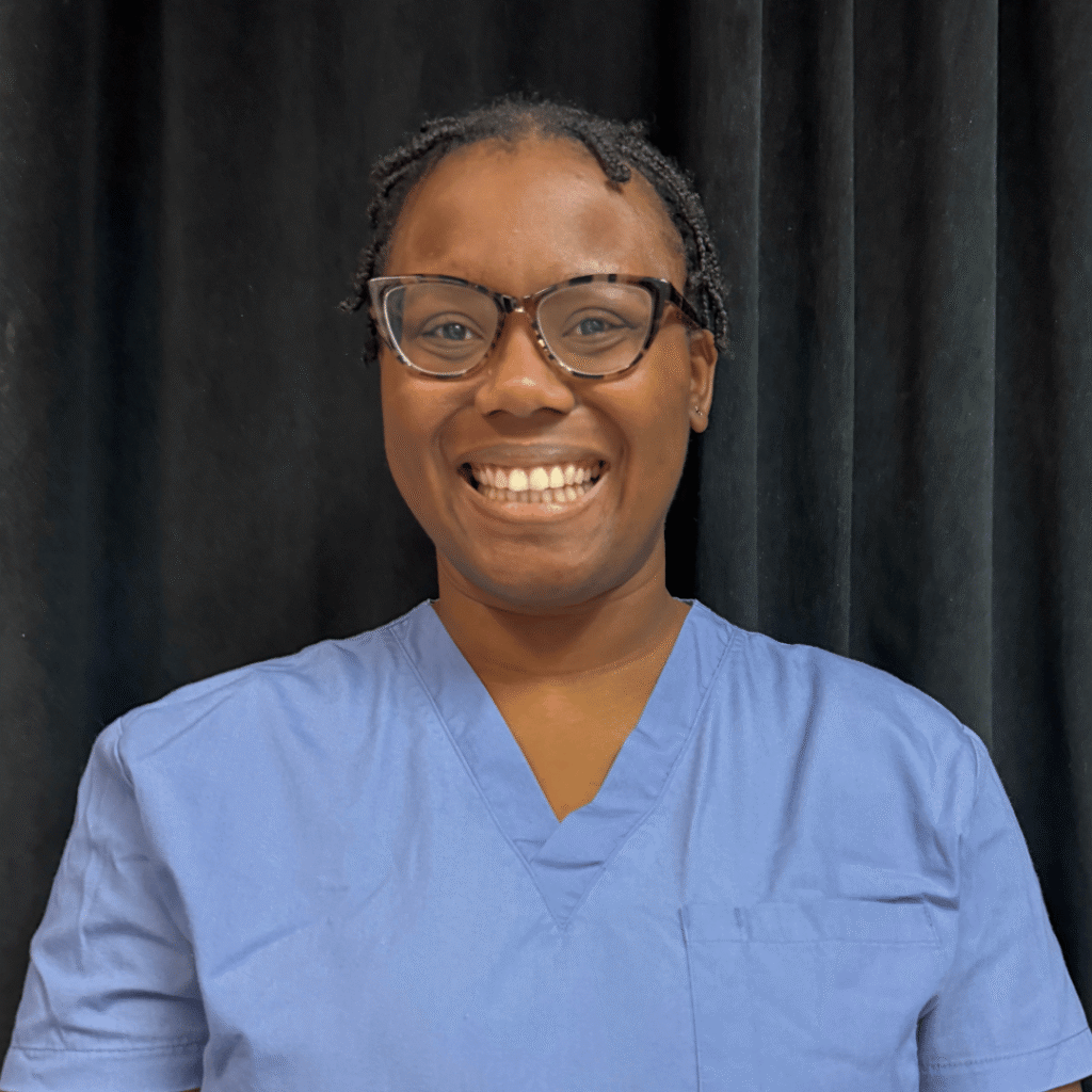Nerissa LMT/massage therapist in light blue scrubs